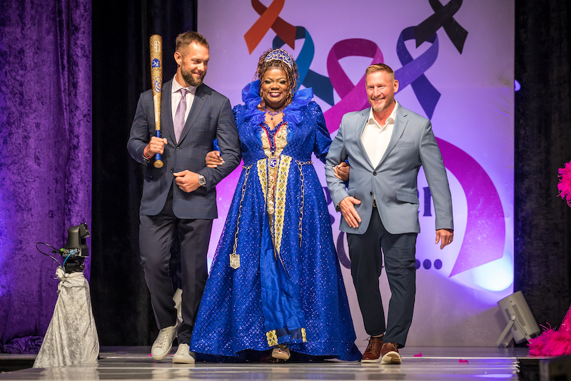 Members of the Kansas City Royals organization escort a model/cancer survivor down the Bra Couture KC runway